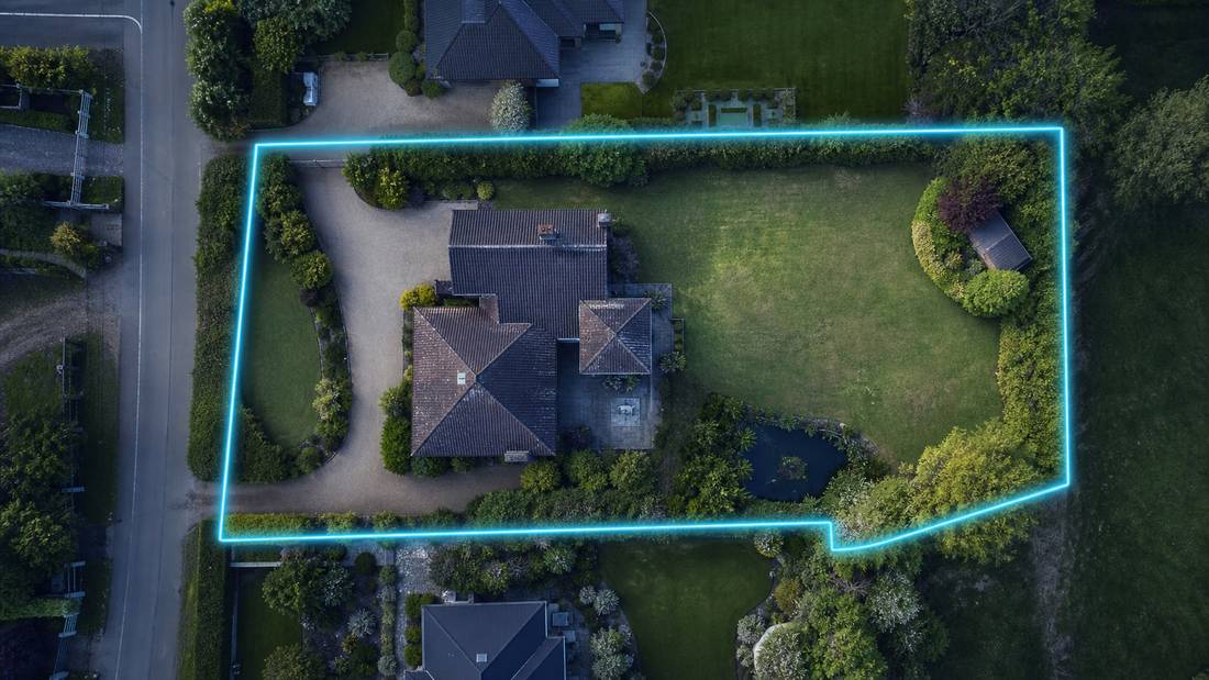 Aerial property image with boundary and lot line graphics marking the plot extent