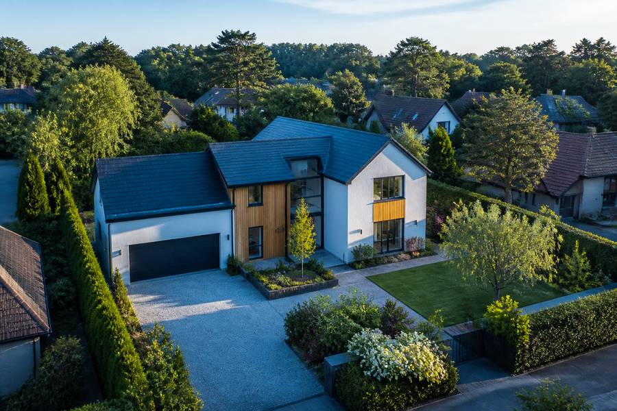 Real estate drone video editing — aerial view of a suburban property and its plot from above